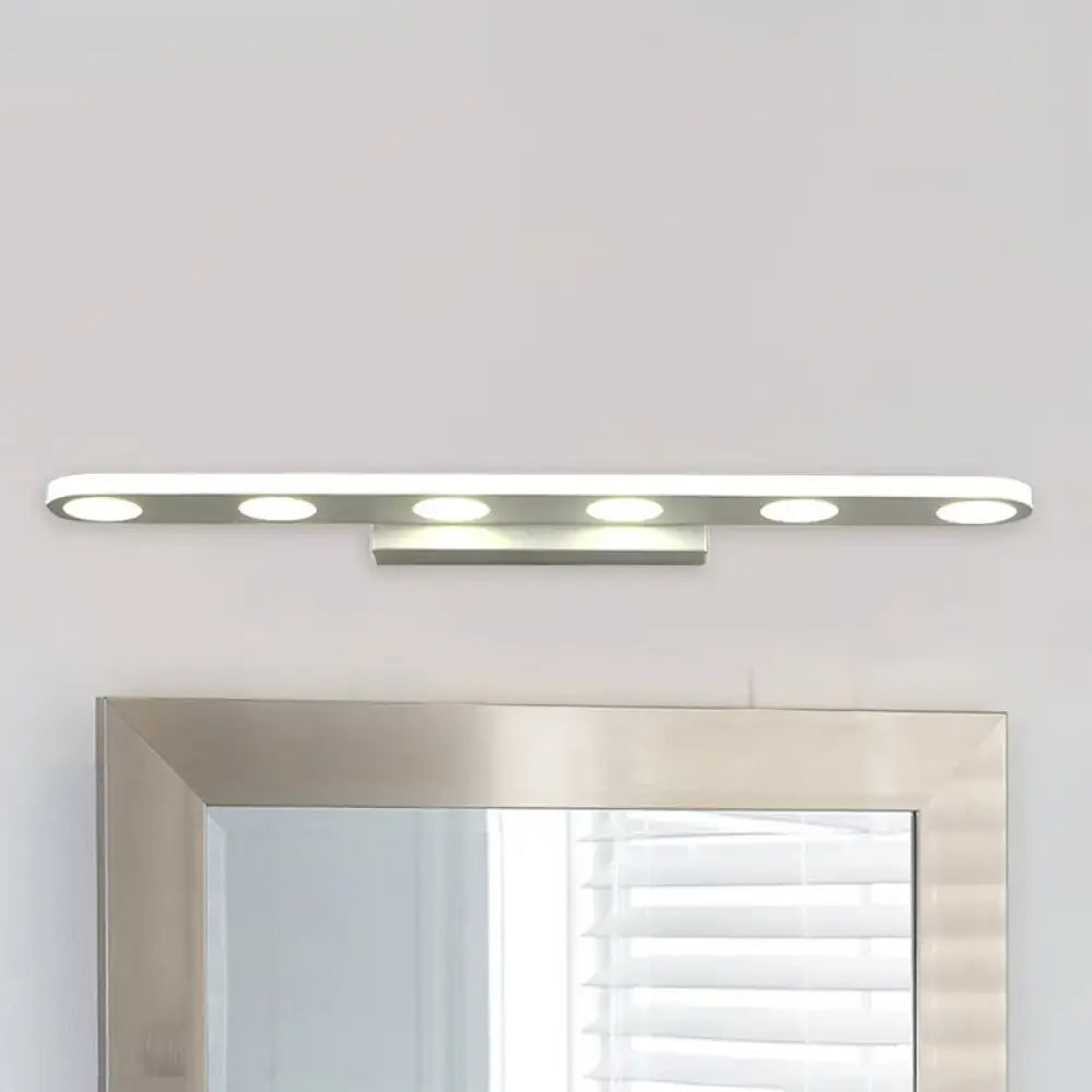 Modern silver oblong acrylic led wall light with five circular bulbs mounted above a bathroom vanity mirror
