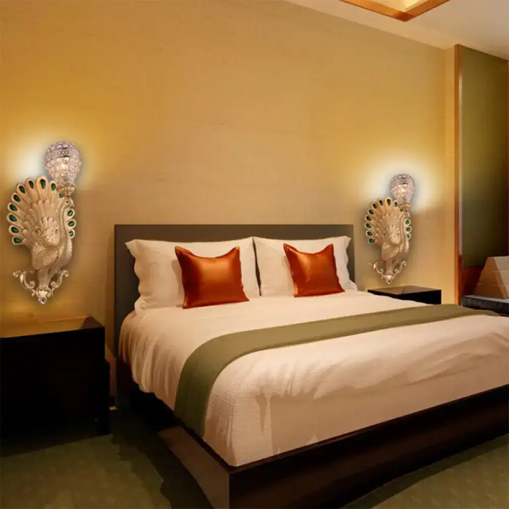 Modern silver peacock wall light with green gemstone accents and crystal globe tops for bedroom wall lighting