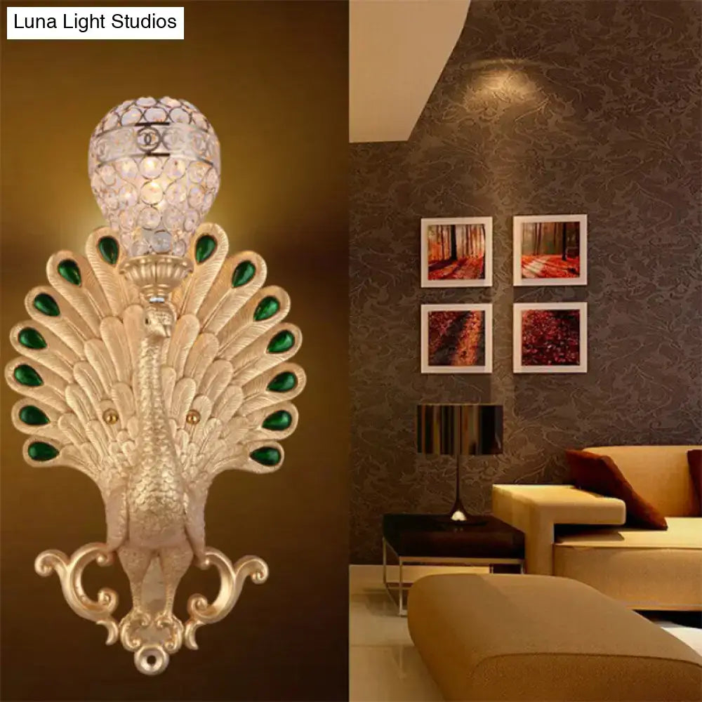 Modern silver peacock wall light with green gemstone accents and crystal globe, perfect as a bedroom sconce wall light