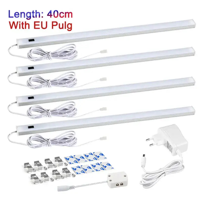 Four white 40cm led cabinet light strips with eu plugs mounting clips and power adapter featuring hand sweep switch