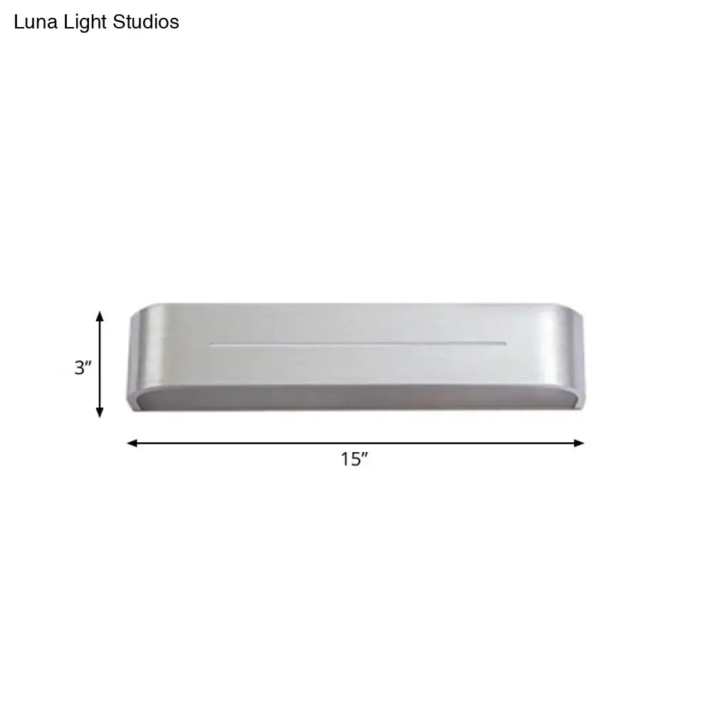 Modern silver rectangular led wall sconce with aluminum shade featuring a sleek design and rounded edges for bedroom use