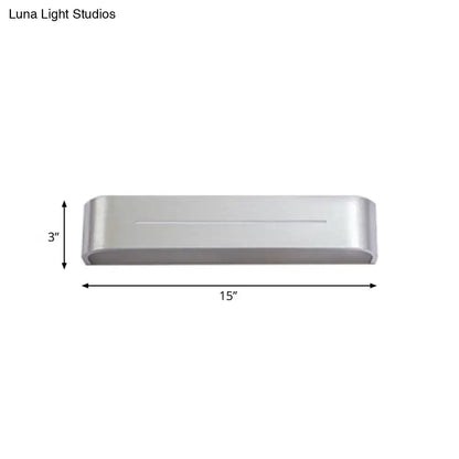 Modern silver rectangular led wall sconce with aluminum shade featuring a sleek design and rounded edges for bedroom use