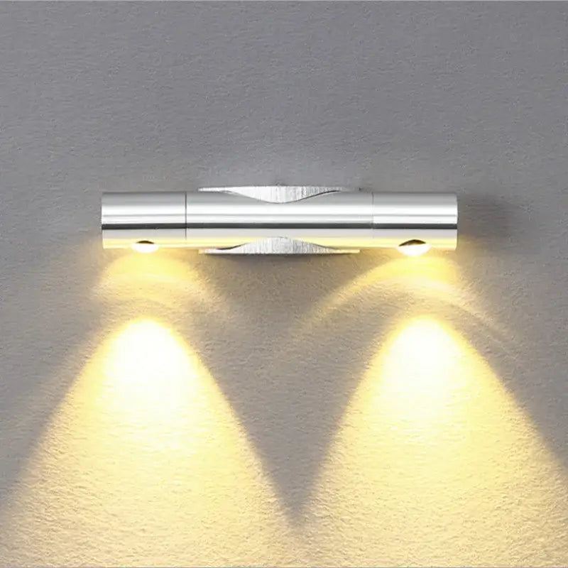 Modern silver metallic rotatable wall lamp with dual adjustable warm yellow led lights for bedroom decorbites wall lamp