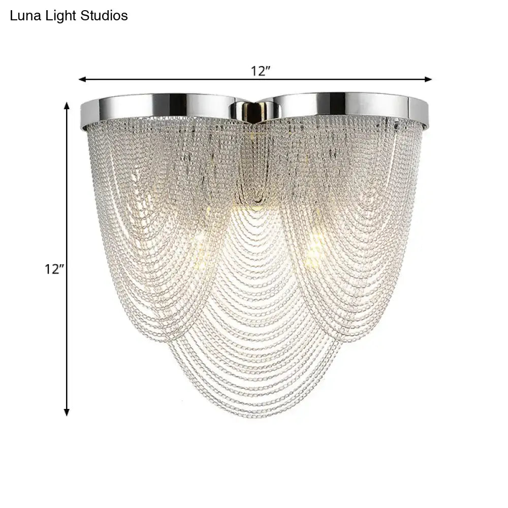 Modern silver tassel chain wall light with chrome finish and cascading clear crystal strands for sitting room use