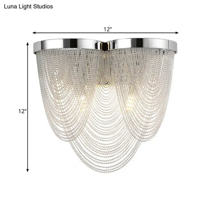 Modern silver tassel chain wall light with chrome finish and cascading clear crystal strands for sitting room use
