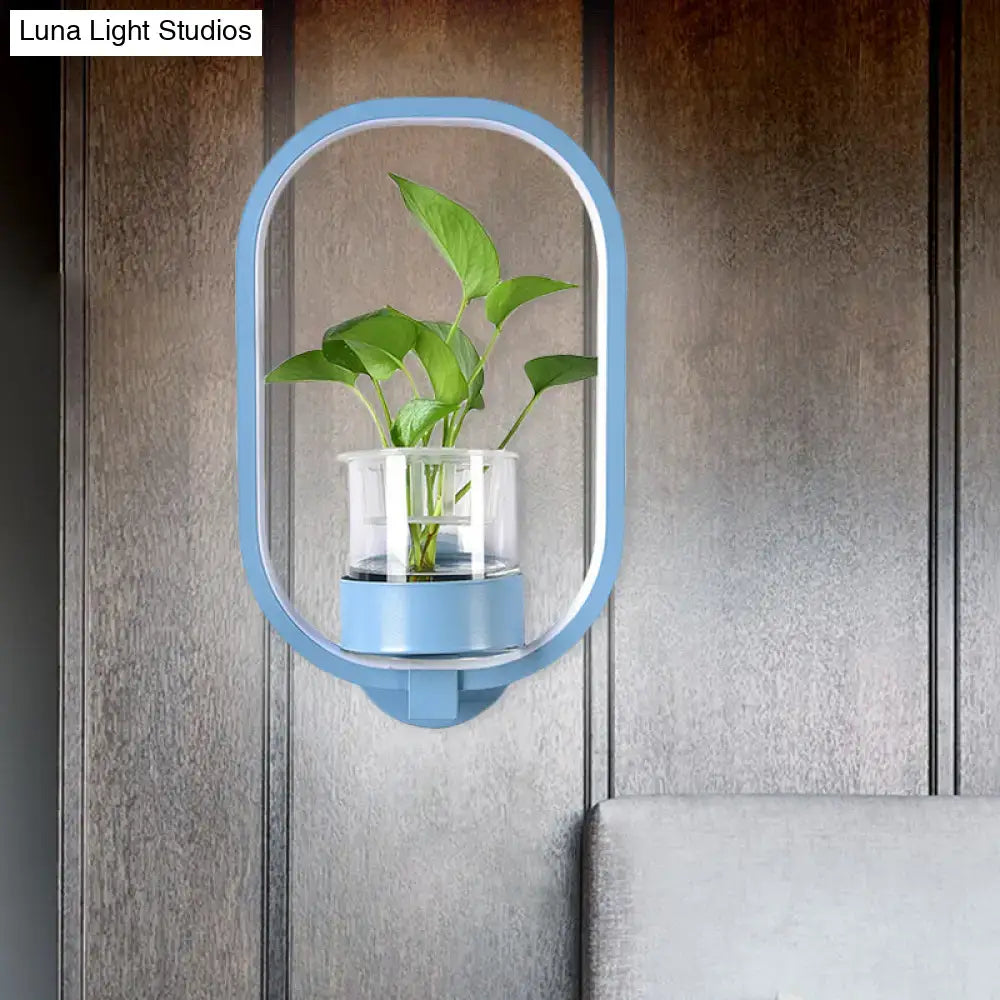 Modern silver wall light with light blue oval wall-mounted plant pot holding green leafy plant 110v-120v bedroom led sconce