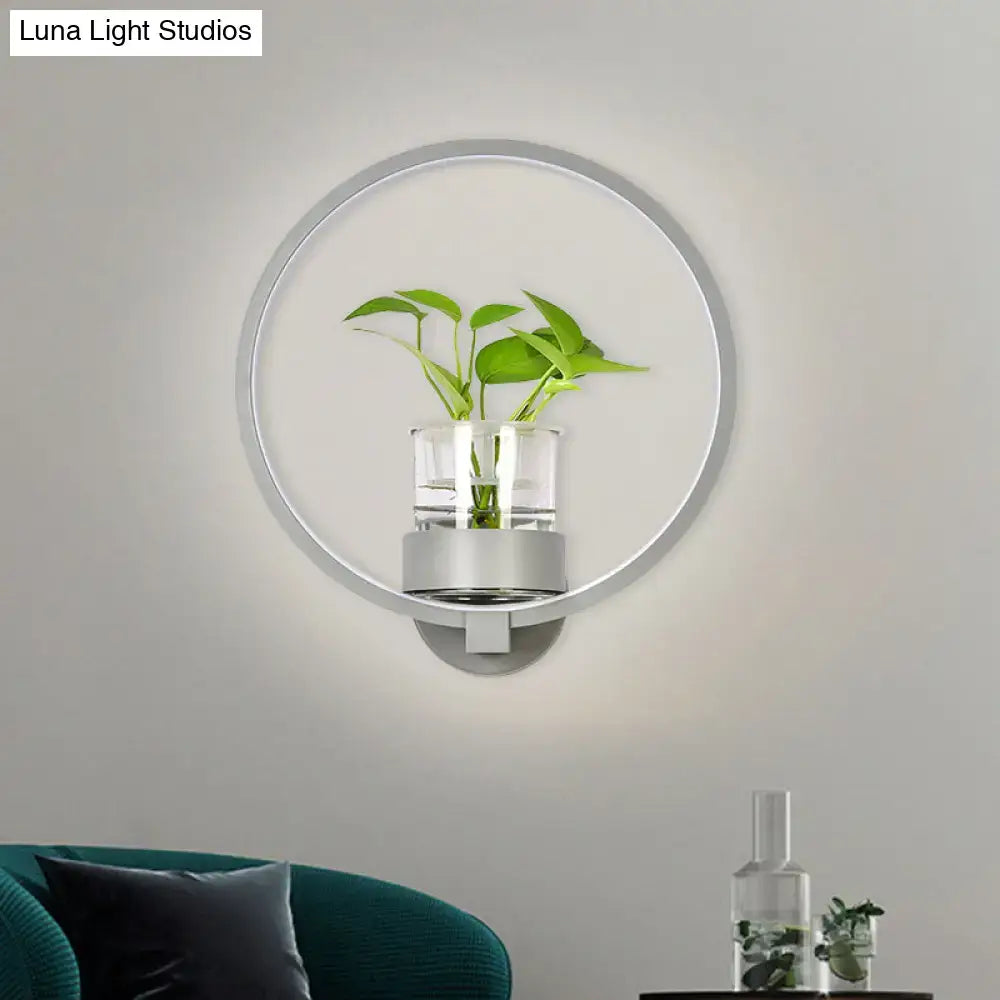 Modern silver wall light with sleek metallic frame and plant pot holding green foliage for bedroom 110v-120v sconce