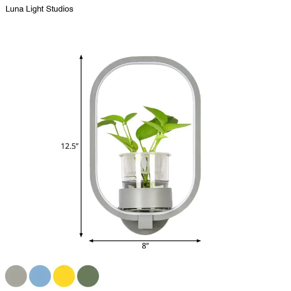 Modern silver wall light with oval plant pot featuring a sleek silver frame and clear glass housing for 110v-120v use