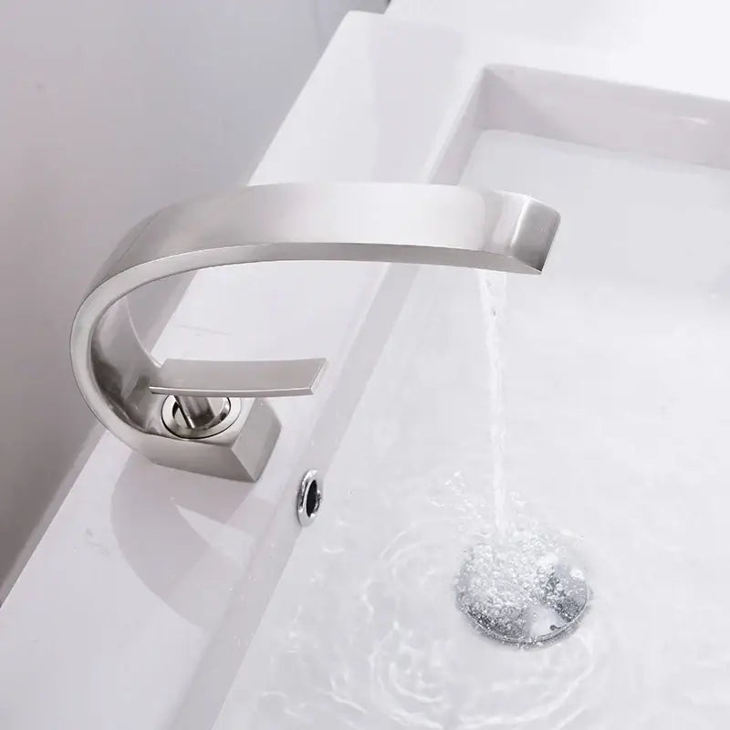 Modern silver waterfall basin faucet with brushed nickel finish and sleek curved spout by decorbites basin faucet