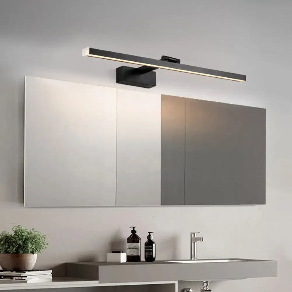 Modern black metal linear vanity mirror light with sleek rectangular design mounted above mirrored cabinet for bathroom use