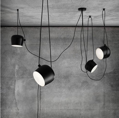 Black matte industrial pendant light with white interior, minimalist design.