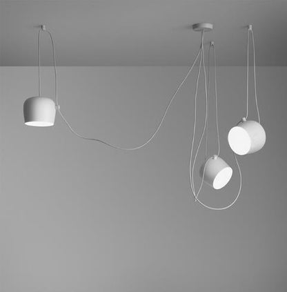 White cylindrical pendant light with integrated cord and minimalist design.