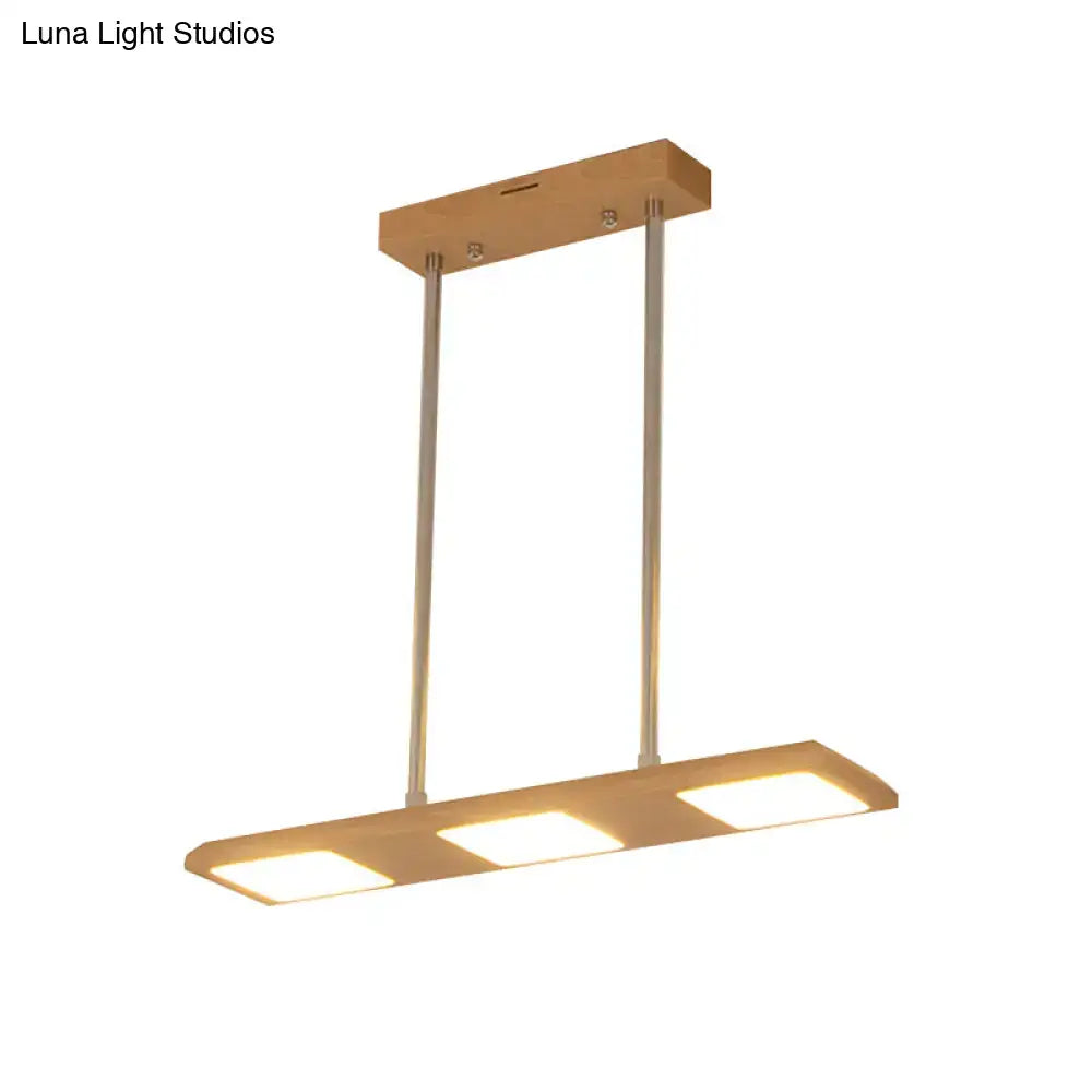 Modern simple rectangle wood island lamp with three warm led panels suspended by metal rods for dining room lighting