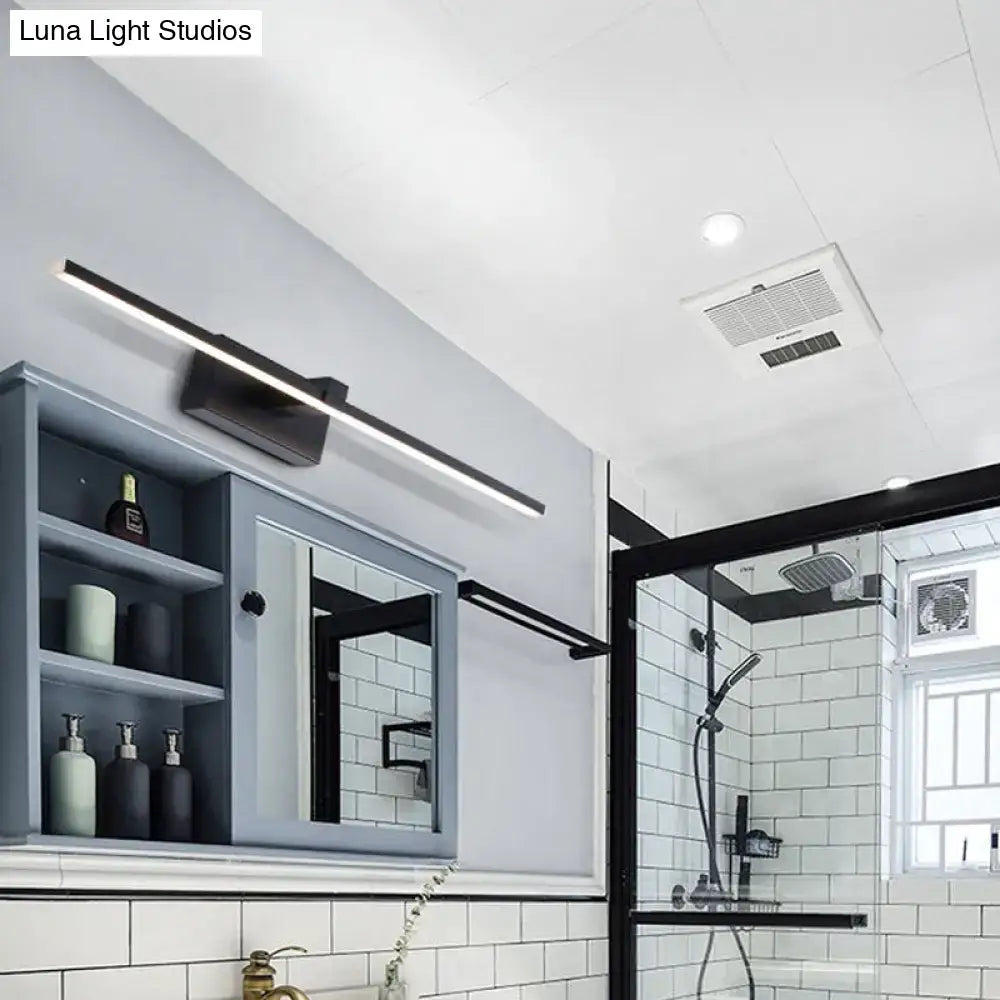Black modern led wall light with sleek rectangular design and matte finish emitting warm white light for bathroom use