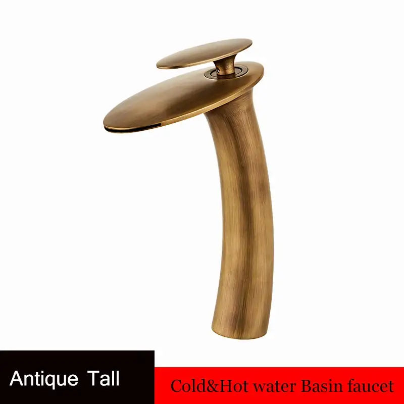 Antique brass waterfall basin faucet with a sleek curved spout and flat oval handle for modern bathroom decor