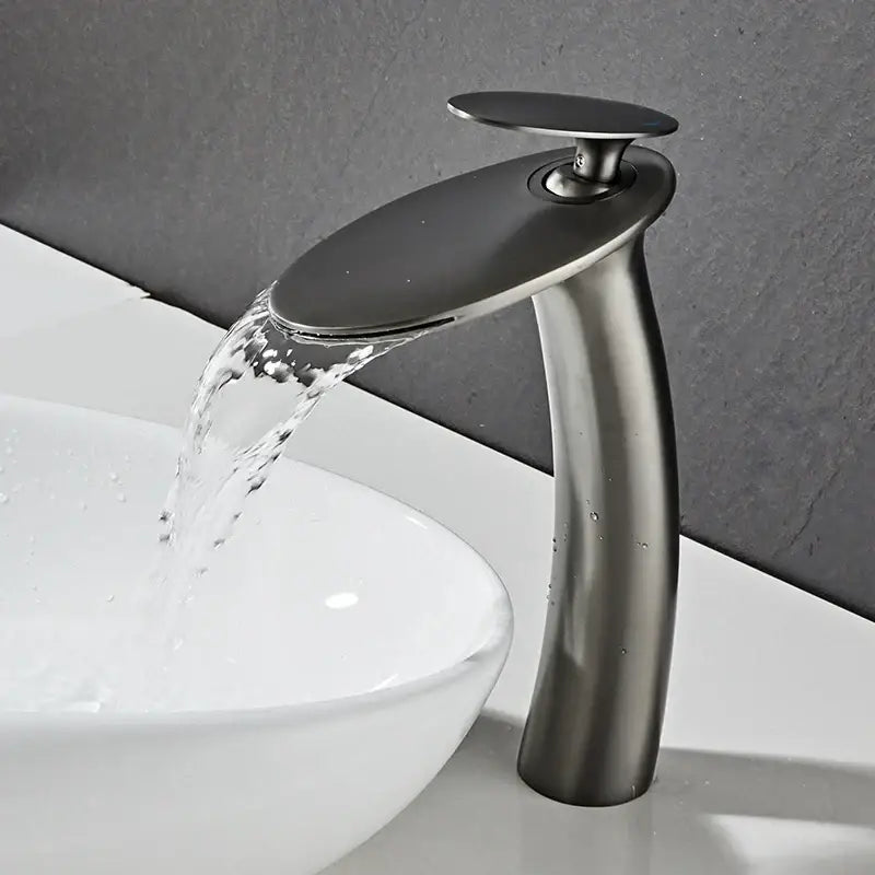 Modern sleek matte black waterfall basin faucet with curved design and brushed metal finish for bathroom decor