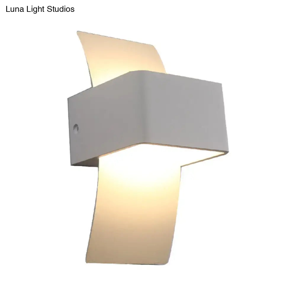 Modern sleek white wall sconce with geometric design and warm diffused led light for bedroom use