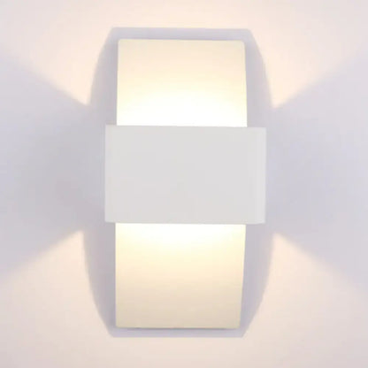 Modern sleek white rectangular wall sconce with minimalist design and warm diffused LED light for bedroom use