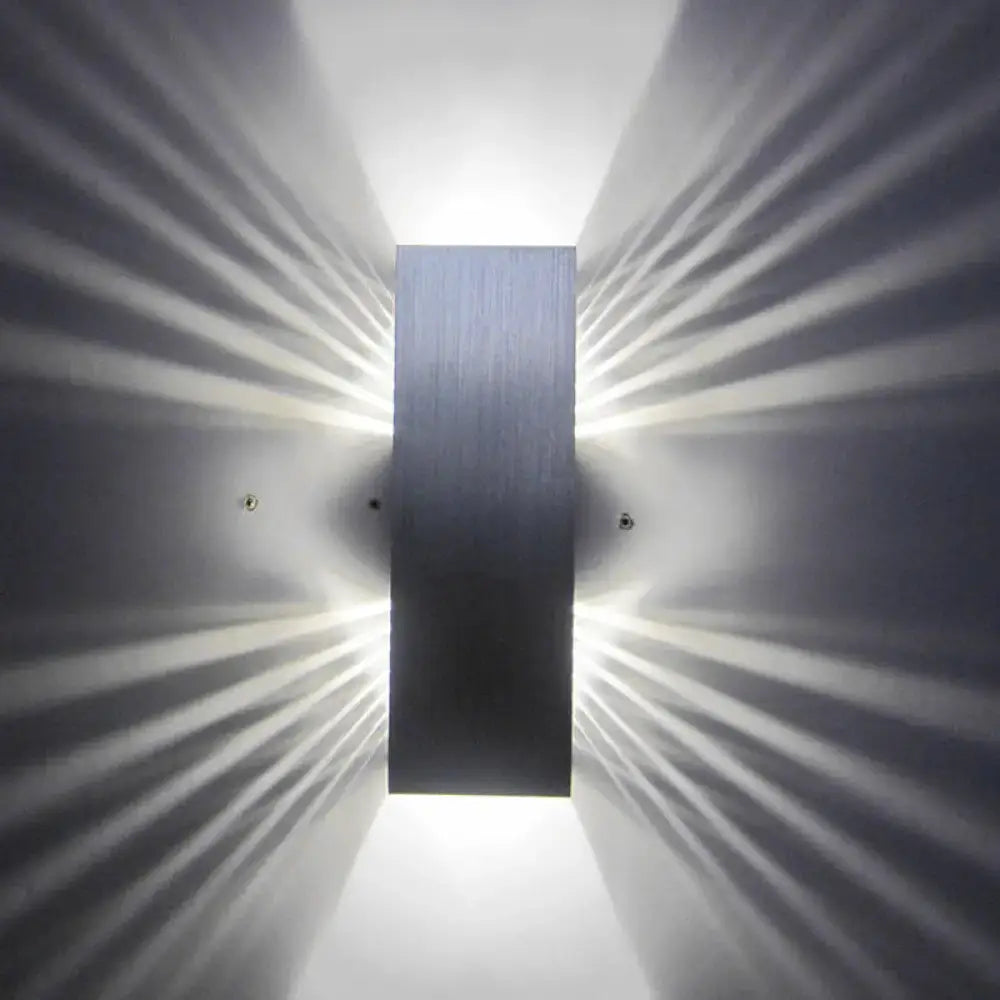 Modern slotted aluminum led wall sconce lamp with brushed metal finish emitting radiant light for living room use