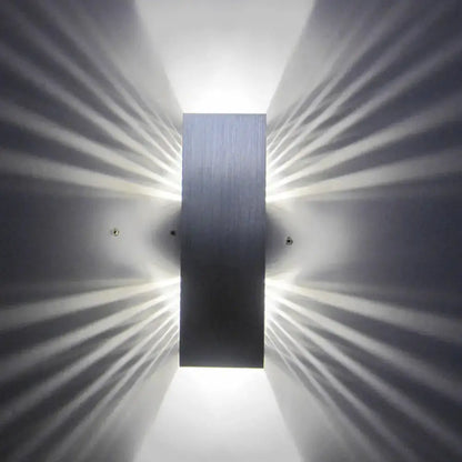 Modern slotted aluminum led wall sconce lamp with brushed metal finish emitting radiant light for living room use