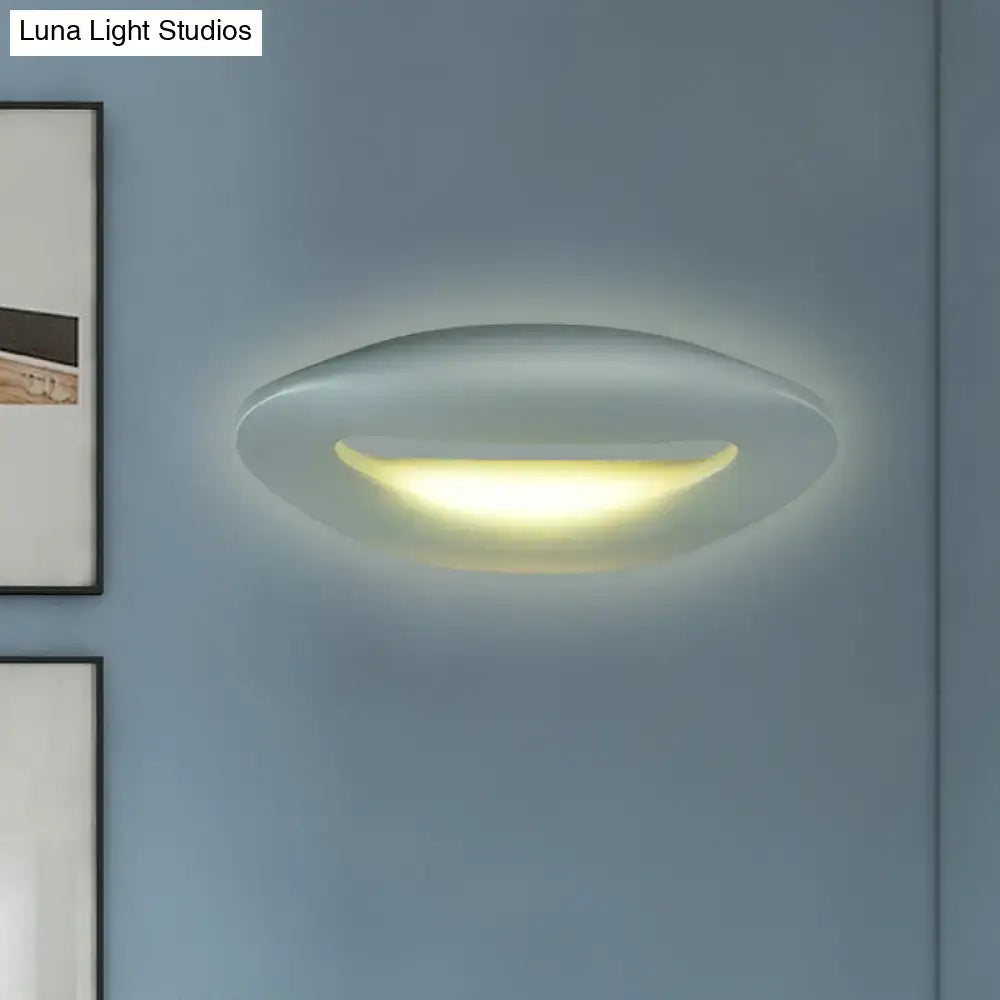 Modern smiling face black white wall lamp with sleek oval design and soft warm glow for corridor lighting