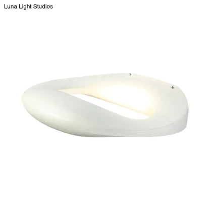 Modern smiling face black white wall lamp with a white oval-shaped frosted glass diffuser and integrated led lighting