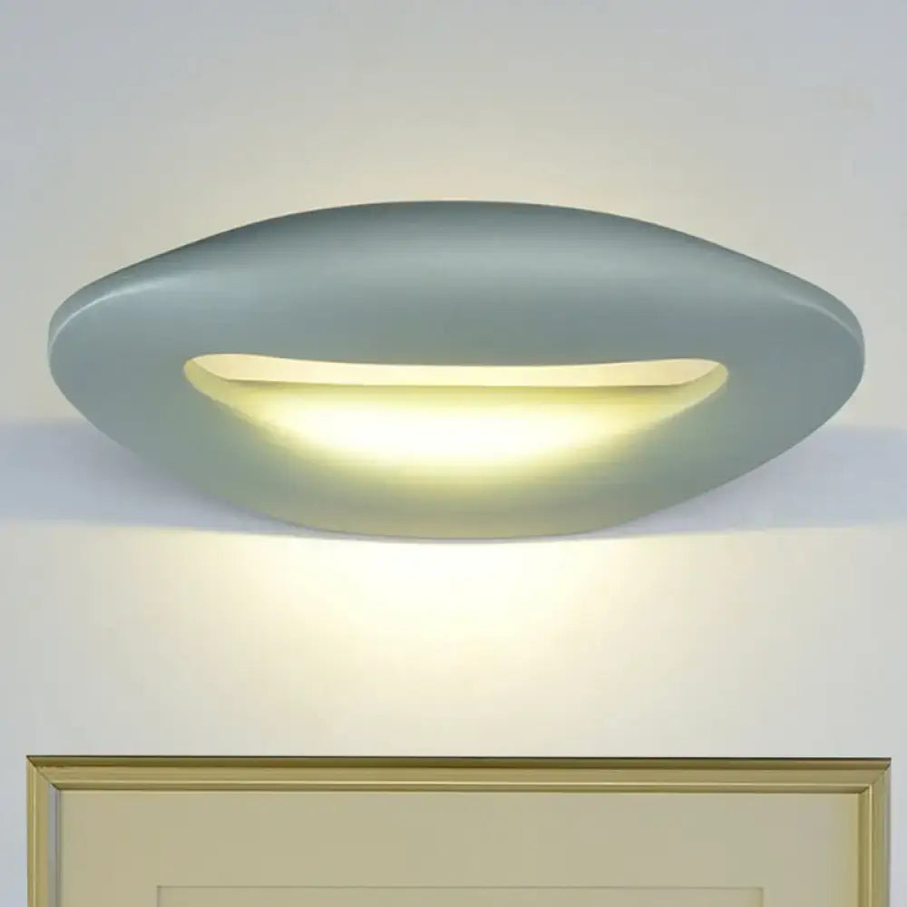 Modern oval-shaped ceiling light with matte gray finish and warm illumination for smiling face black white wall lamp use