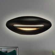 Modern black and white smiling face wall lamp with sleek oval ceiling light design and warm ambient glow for corridors