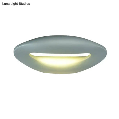 Modern smiling face black white led wall lamp with sleek matte gray oval ceiling light and warm yellow illumination