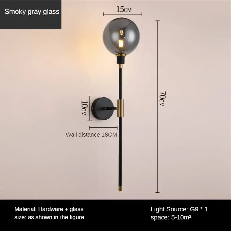 A modern smoked glass ball led wall light with smoky gray glass globe black metal rod and gold accents for bedroom decorbites wall light