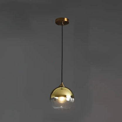 Gold-finished glass ball pendant light with clear smoked glass globe and black cord for kitchen and dining decorbites pendant lights