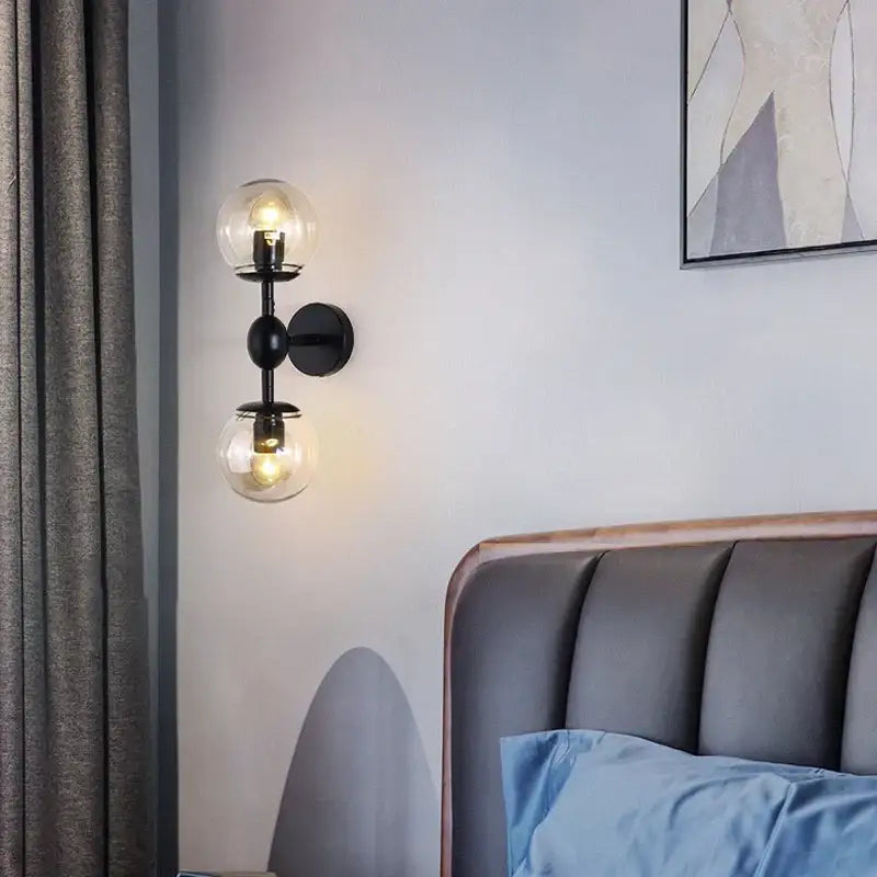 Black metal decorbites glass beans wall sconce with two clear smoked glass globe shades for bedroom lighting