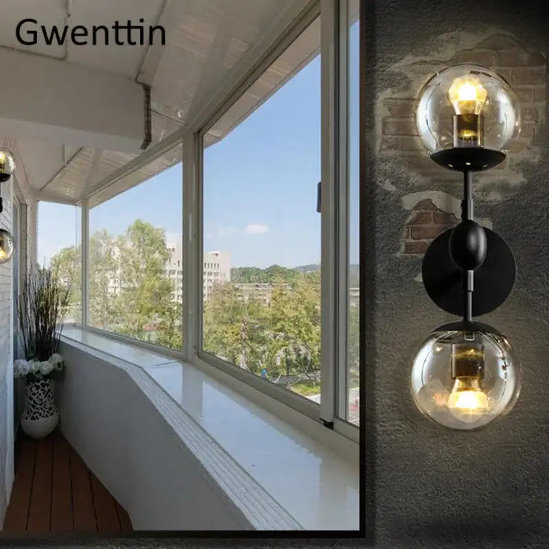 Black metal decorbites glass beans wall sconce with two clear glass globe shades and exposed filament bulbs for bedroom light