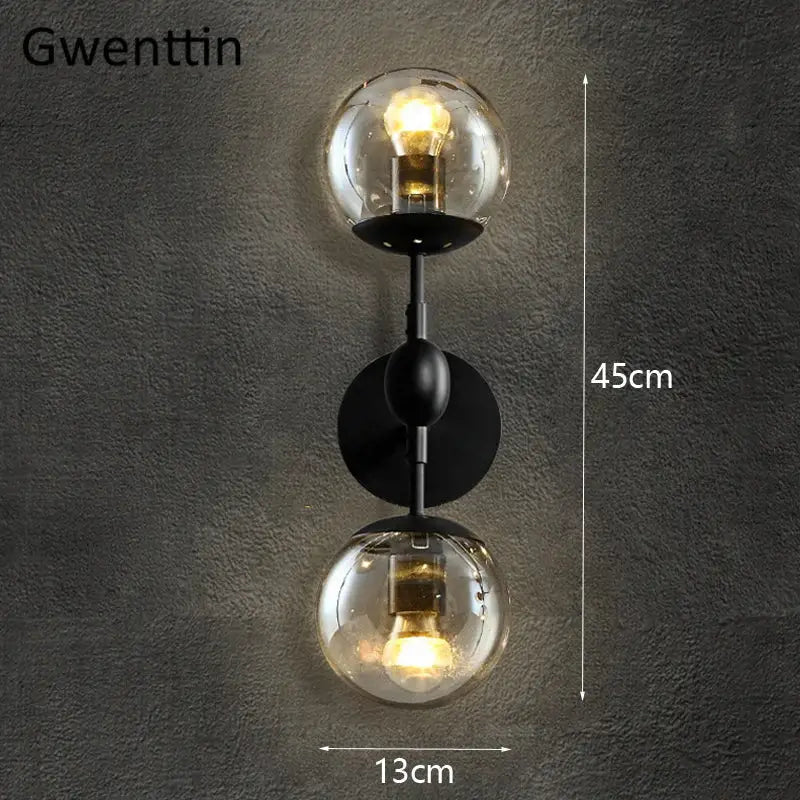Black metal decorbites glass beans wall sconce with two clear glass globe shades and exposed filament bulbs for bedroom lighting