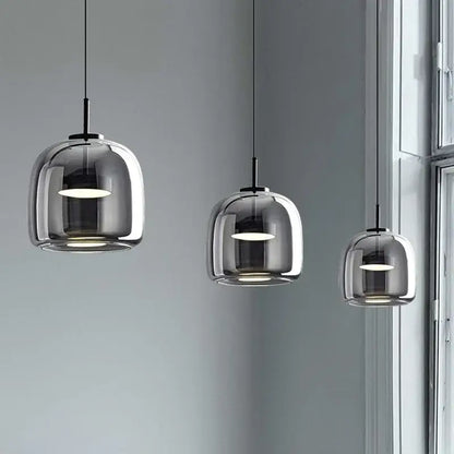 Modern smoked glass bowl chandelier with three translucent smoked glass domes and black metal fixtures for dining room