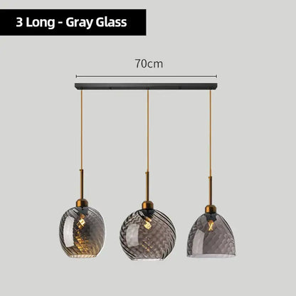 Set of three modern pendant lights with gray textured glass chandelier pendant shades and brass-finished metal fixtures