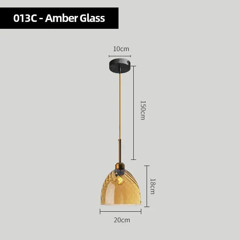 Amber glass pendant lights set of 4 with textured dome-shaped shades and brass-toned hardware for kitchen use
