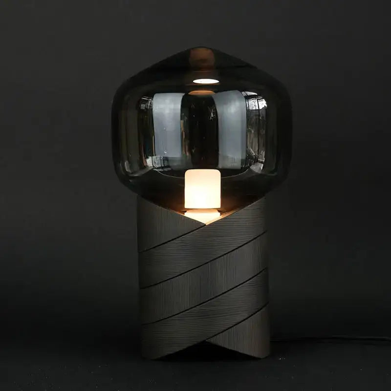 A modern smoked glass creative resin n823 lamp with a dark globe and textured gray resin base for bedroom decor