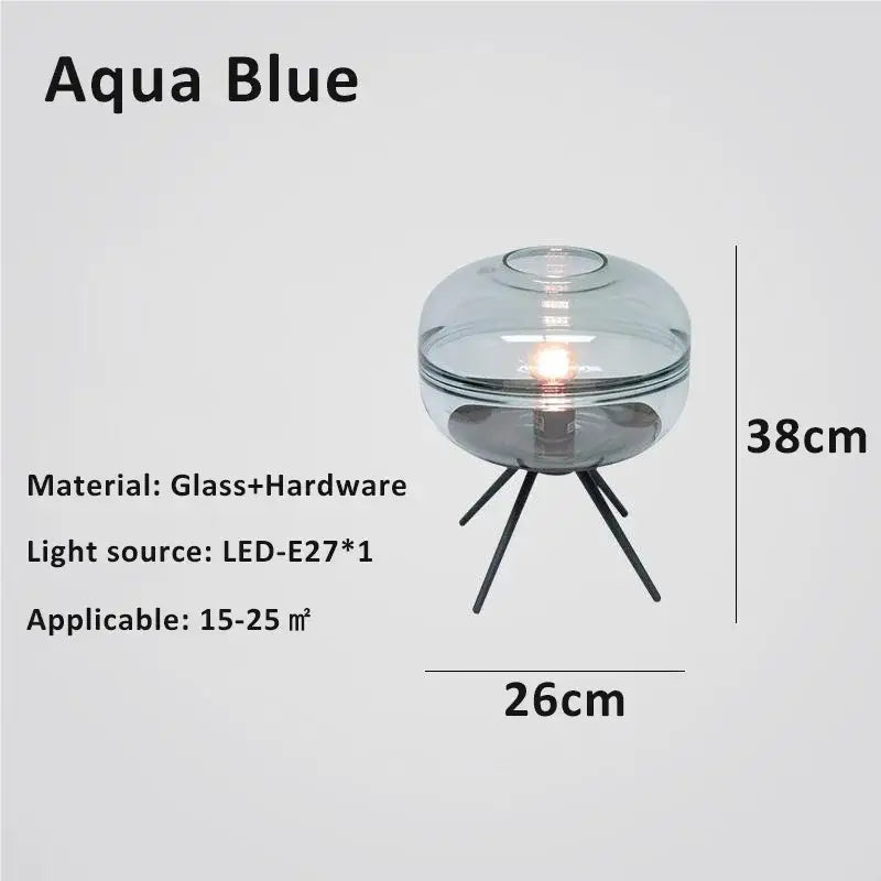 Modern smoked glass desk lamp in aqua blue with sleek spherical design and black metal tripod base from decorbites glass desk