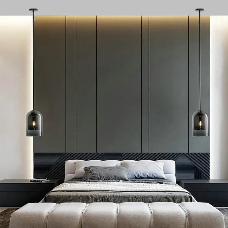 Modern smoked glass led chandelier with black pendant lamps and glass led shades hanging above a sleek bed
