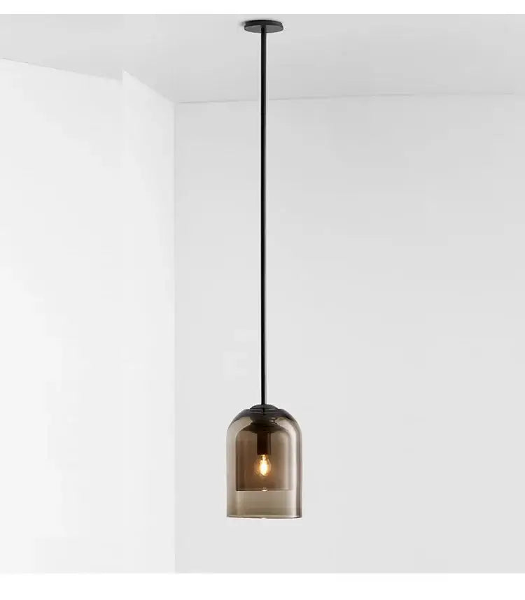 A sleek black modern smoked glass led chandelier with an exposed bulb for dining room lighting