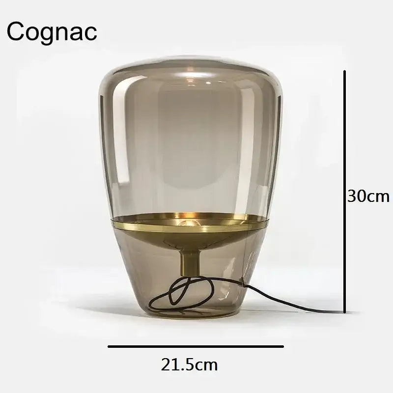 A sleek 30cm tall cognac glass table lamp with brass accents perfect as a modern glass table lamp for desks