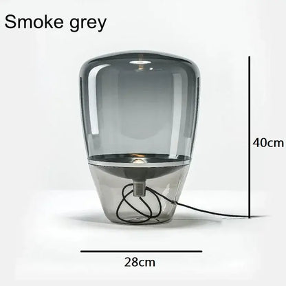 Smoke grey glass table lamp with metallic base featuring a sleek modern design ideal for bedroom or desk use
