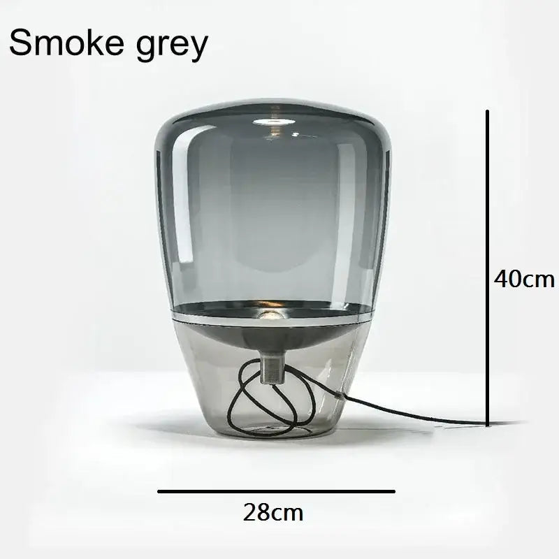 Smoke grey glass table lamp with metallic base featuring a sleek modern design ideal for bedroom or desk use