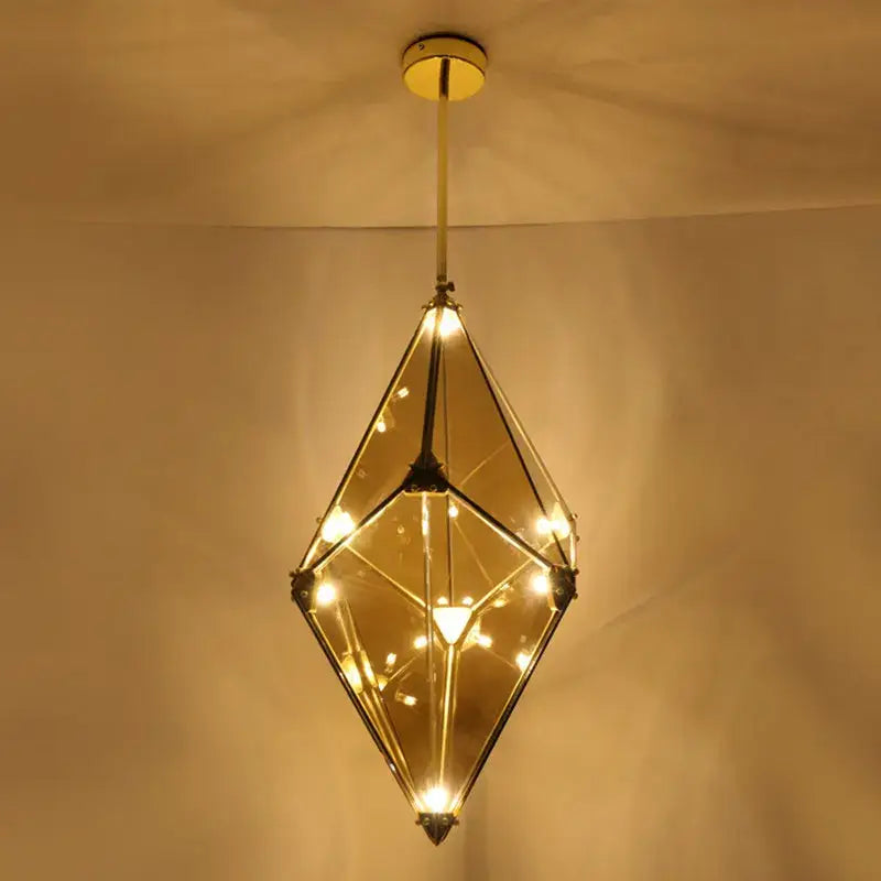 Modern smoky gray and amber diamond glass led pendant light with brass framing and warm bulbs for living room use