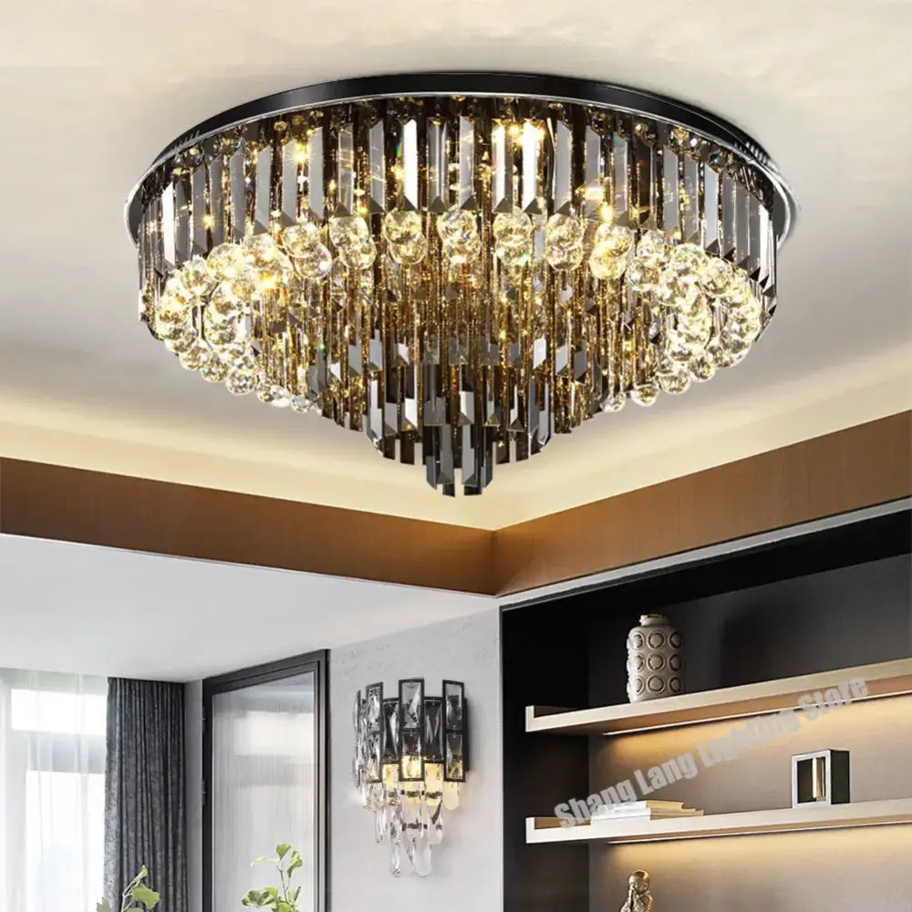 Modern smoky gray and gold decorbites crystal led chandelier with black metal frame and cascading clear prisms for living room decor
