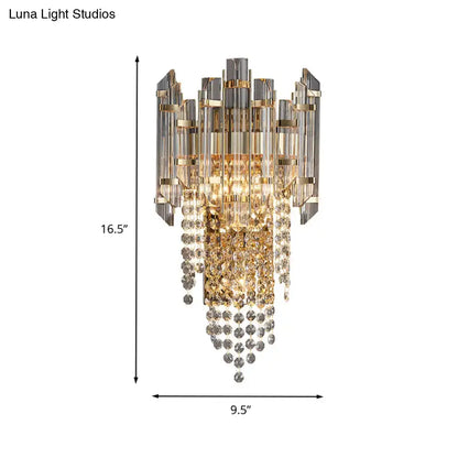 Modern smoky grey crystal wall sconce featuring a gold and clear crystal chandelier with a cascading design for living rooms