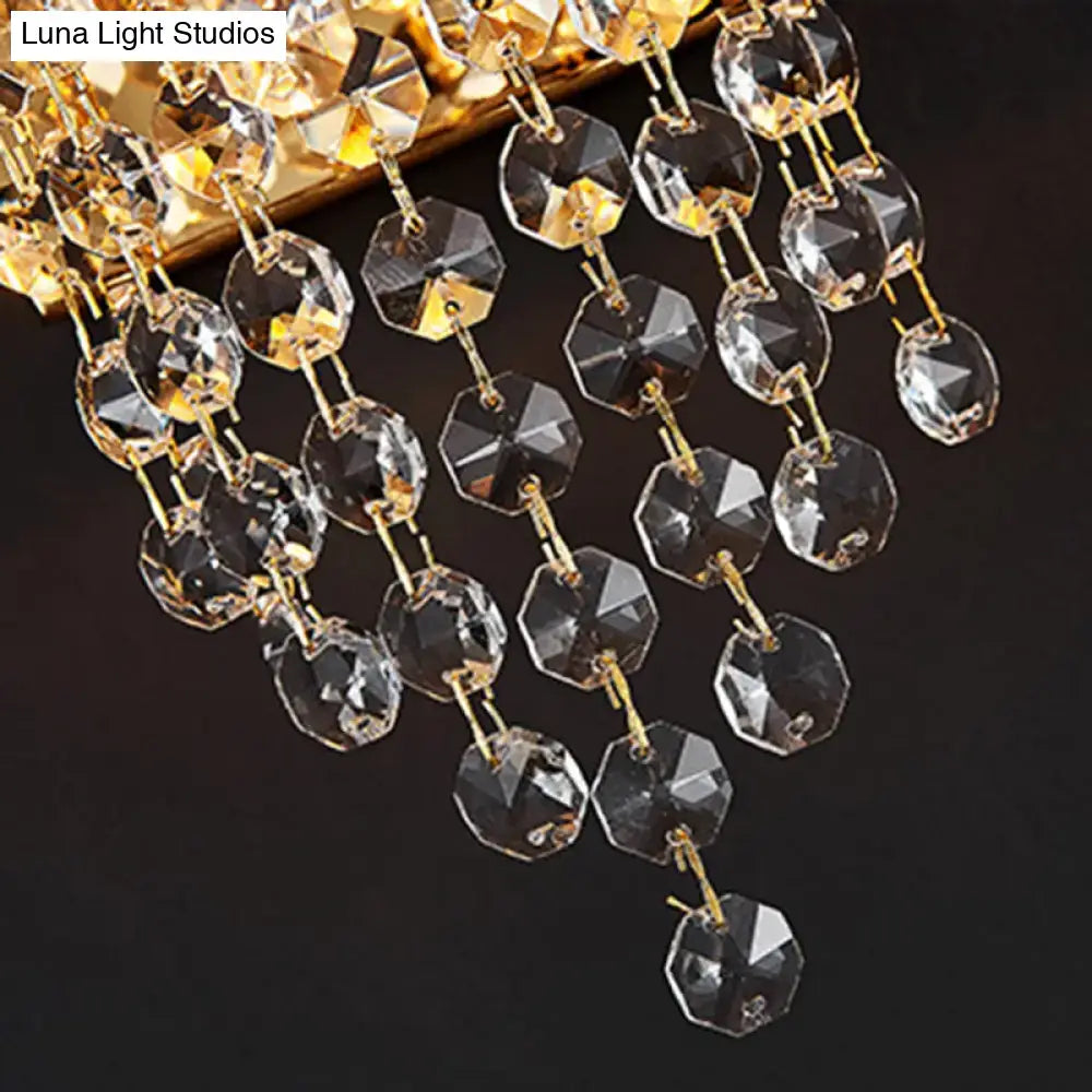 Modern smoky grey crystal wall sconce featuring a golden-toned crystal pendant with clear and amber faceted beads