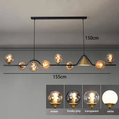 Modern black metal pendant light fixture with smoky grey glass globes and gold accent for dining room use