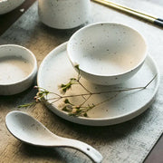 White ceramic dinner plate set with subtle black speckles featuring a bowl and matching plate for modern dining